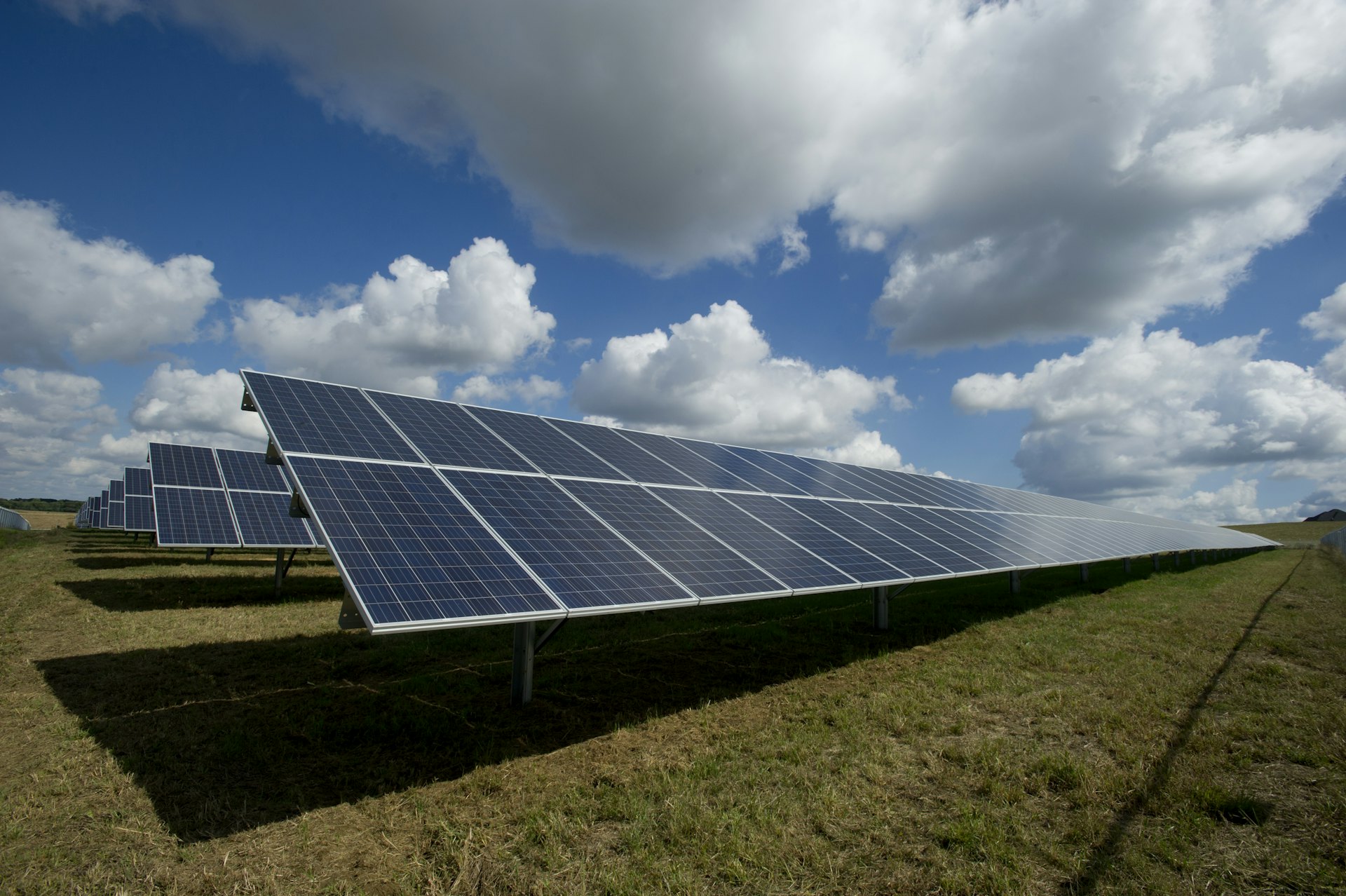 Rows of rooftop-scale solar panels angled toward a clear sky.